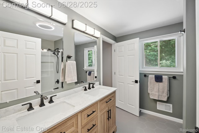 8409 Sandpiper St, Canton, MI 48187 - bathroom featuring double vanity and tile patterned flooring