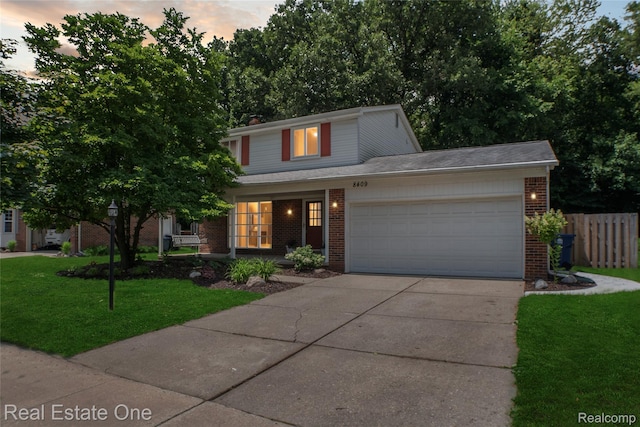 8409 Sandpiper St, Canton, MI 48187 - traditional home with brick siding, a garage, concrete driveway, and covered porch