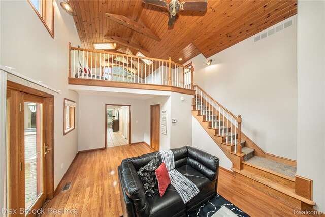 6730 Halyard Rd, Bloomfield Hills, MI 48301 - living room with wooden ceiling, stairs, ceiling fan, wood finished floors, and high vaulted ceiling