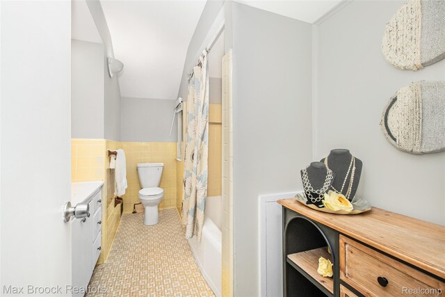 6730 Halyard Rd, Bloomfield Hills, MI 48301 - full bathroom with tile walls, vanity, a wainscoted wall, and shower / tub combo