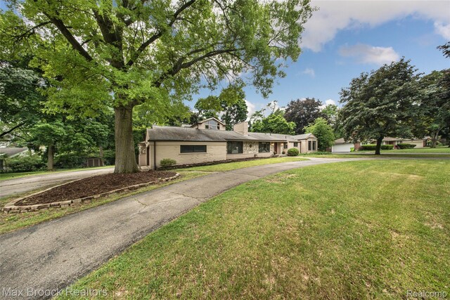 6730 Halyard Rd, Bloomfield Hills, MI 48301 - mid-century modern home with driveway, a front yard, a chimney, and brick siding