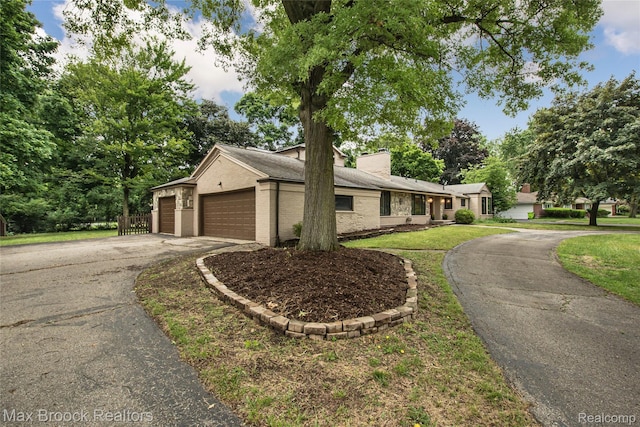 6730 Halyard Rd, Bloomfield Hills, MI 48301 - mid-century inspired home with driveway, an attached garage, brick siding, a chimney, and a front yard