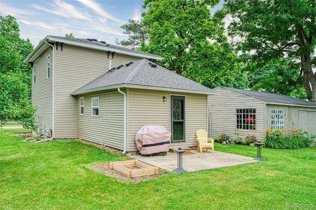 405 Garden Ln, Fowlerville, MI 48836 - back of property with a patio, a lawn, and a shingled roof