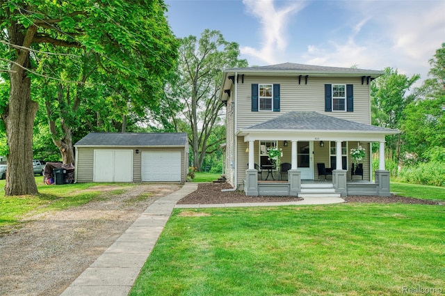 405 Garden Ln, Fowlerville, MI 48836 - american foursquare style home with a porch, an outbuilding, a front yard, a detached garage, and driveway