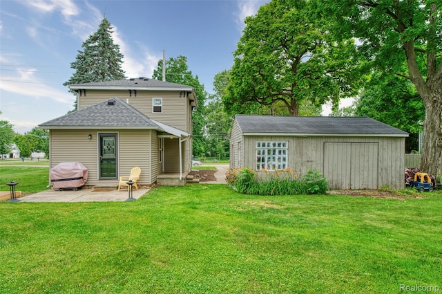 405 Garden Ln, Fowlerville, MI 48836 - back of house featuring a patio area, a lawn, an outdoor structure, and a shingled roof