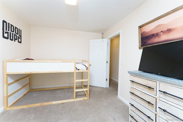 405 Garden Ln, Fowlerville, MI 48836 - unfurnished bedroom featuring carpet floors and baseboards