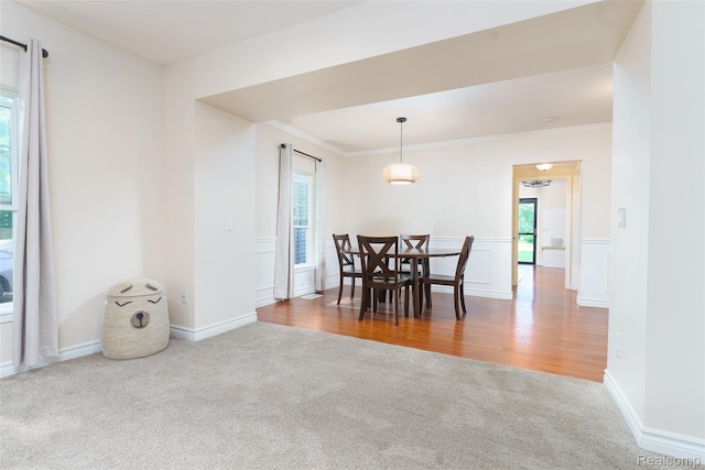 405 Garden Ln, Fowlerville, MI 48836 - carpeted dining room featuring healthy amount of natural light, ornamental molding, and wood finished floors