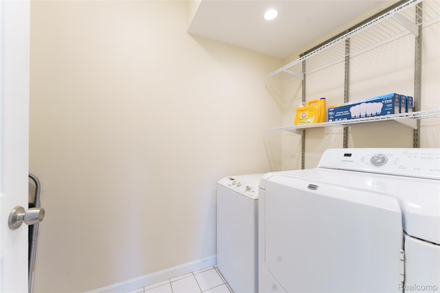 405 Garden Ln, Fowlerville, MI 48836 - laundry room with washer and dryer and light tile patterned floors