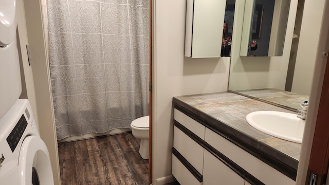 3400 Lakeside Dr S Unit 17, Petoskey, MI 49770 - bathroom featuring washer / dryer, wood finished floors, vanity, and a shower with curtain