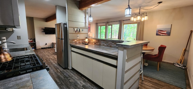 3400 Lakeside Dr S Unit 17, Petoskey, MI 49770 - kitchen featuring freestanding refrigerator, dark wood finished floors, beam ceiling, white cabinets, and a breakfast bar