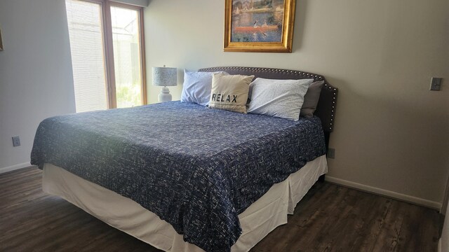 3400 Lakeside Dr S Unit 17, Petoskey, MI 49770 - bedroom featuring baseboards and dark wood-style floors