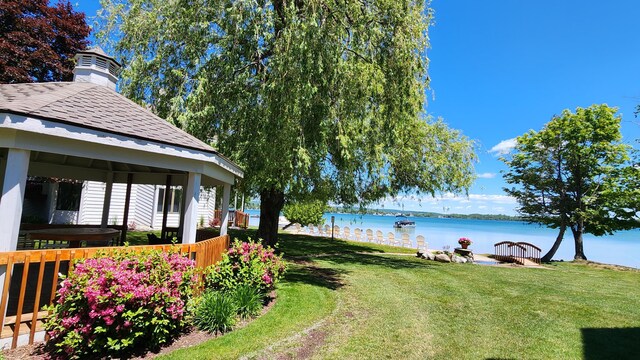 3400 Lakeside Dr S Unit 17, Petoskey, MI 49770 - view of green lawn with a water view, a gazebo, and a covered hot tub