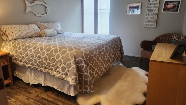 3400 Lakeside Dr S Unit 17, Petoskey, MI 49770 - bedroom with dark wood-style flooring and baseboards