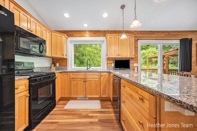 8035 Jericho Ave NE, Rockford, MI 49341 - kitchen with black appliances, light wood-style floors, vaulted ceiling, recessed lighting, and pendant lighting