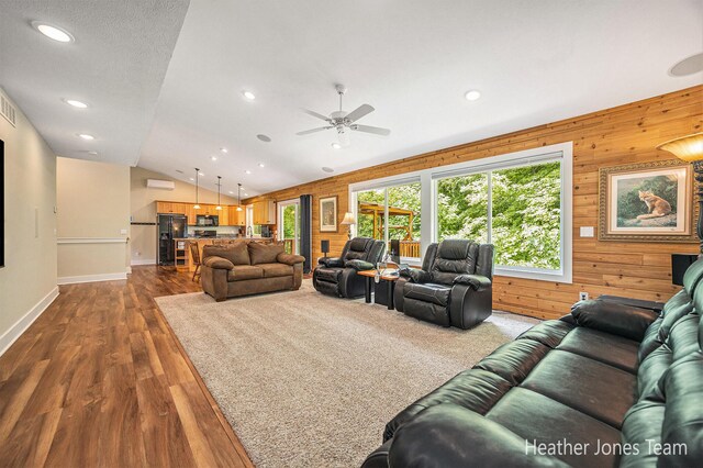 8035 Jericho Ave NE, Rockford, MI 49341 - living room with wooden walls, recessed lighting, a ceiling fan, dark wood-type flooring, and vaulted ceiling