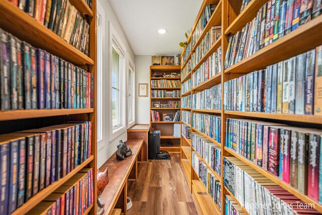 8035 Jericho Ave NE, Rockford, MI 49341 - living area with bookshelves, wood finished floors, and recessed lighting