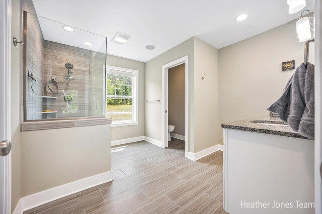 8035 Jericho Ave NE, Rockford, MI 49341 - full bath with a tile shower, vanity, recessed lighting, and wood finished floors