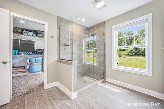 8035 Jericho Ave NE, Rockford, MI 49341 - bathroom featuring a stall shower, a walk in closet, and recessed lighting