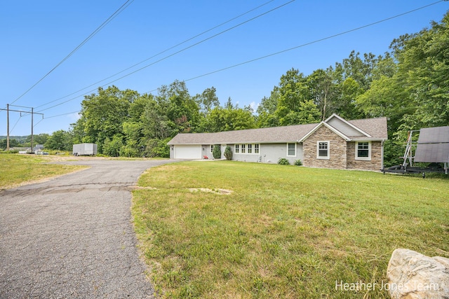 8035 Jericho Ave NE, Rockford, MI 49341 - ranch-style home featuring driveway, an attached garage, stone siding, and a front yard