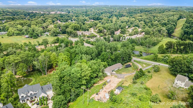 8035 Jericho Ave NE, Rockford, MI 49341 - aerial view of property and surrounding area featuring a heavily wooded area
