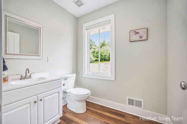 8035 Jericho Ave NE, Rockford, MI 49341 - half bath with vanity and wood finished floors