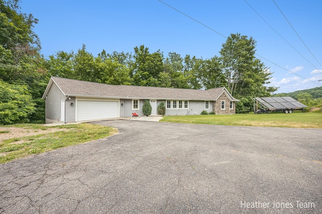 8035 Jericho Ave NE, Rockford, MI 49341 - single story home featuring an attached garage, asphalt driveway, and a front yard
