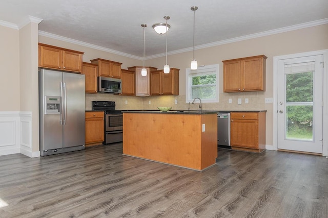 6107 Equestrian Woods Ct, Kalamazoo, MI 49009 - kitchen featuring appliances with stainless steel finishes, dark wood finished floors, brown cabinets, dark countertops, and backsplash