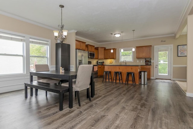 6107 Equestrian Woods Ct, Kalamazoo, MI 49009 - dining space featuring a chandelier, dark wood-type flooring, and ornamental molding