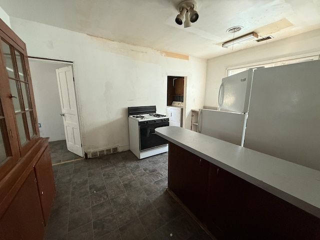 223 Washington Ave, Lakeview, MI 48850 - kitchen with white appliances, washer / clothes dryer, and light countertops