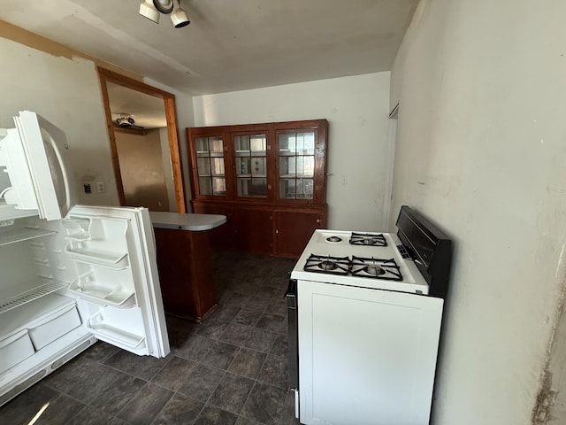 223 Washington Ave, Lakeview, MI 48850 - kitchen with white gas stove and a peninsula
