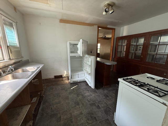 223 Washington Ave, Lakeview, MI 48850 - kitchen with gas range gas stove, light countertops, and dark stone finish flooring