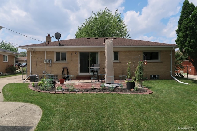 28242 Aline Dr, Warren, MI 48093 - back of house with brick siding, a patio area, a lawn, and a chimney