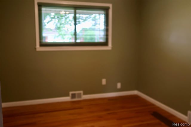 28242 Aline Dr, Warren, MI 48093 - spare room featuring wood finished floors and baseboards