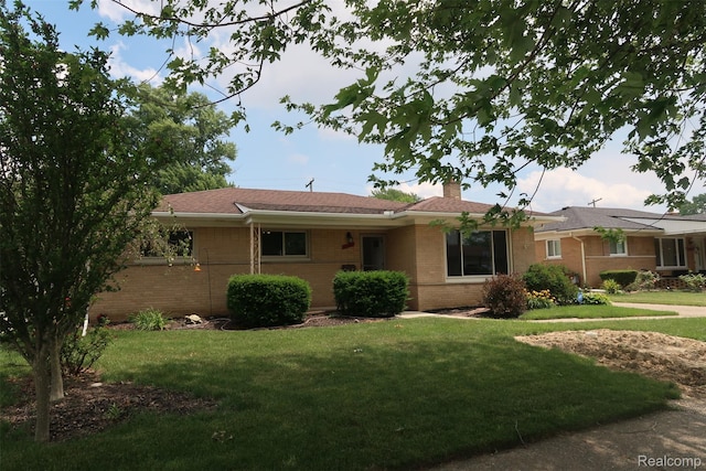 28242 Aline Dr, Warren, MI 48093 - ranch-style house with brick siding, a chimney, and a front lawn