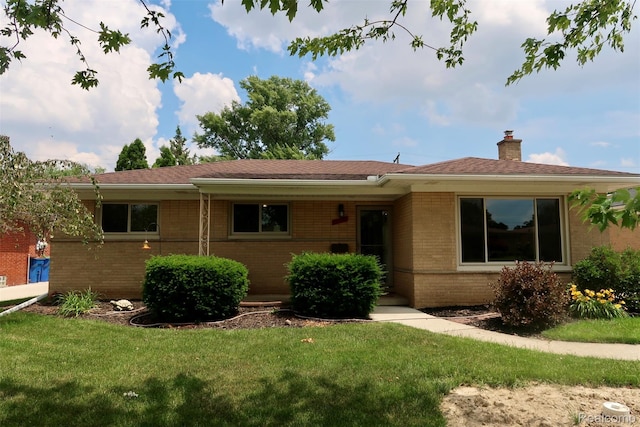 28242 Aline Dr, Warren, MI 48093 - single story home with brick siding, a front lawn, and a chimney