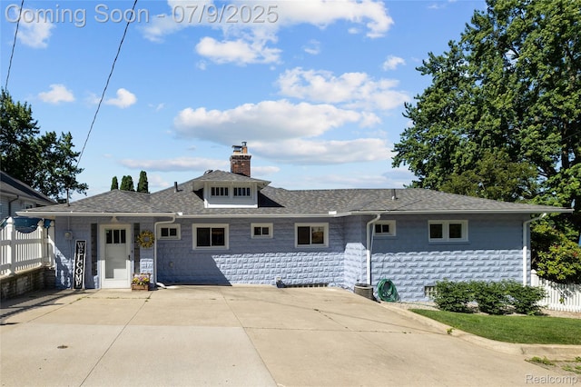 108 Highland Ave, Lake Orion, MI 48362 - view of front of house featuring a chimney, a patio, and roof with shingles
