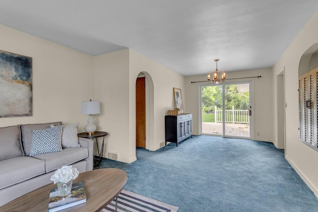 5951 Riverside Dr, Jackson, MI 49201 - carpeted living area featuring arched walkways and a chandelier
