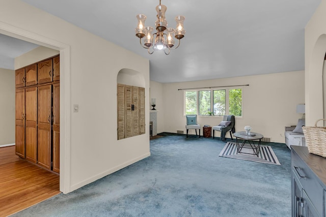5951 Riverside Dr, Jackson, MI 49201 - carpeted dining area with arched walkways and a chandelier