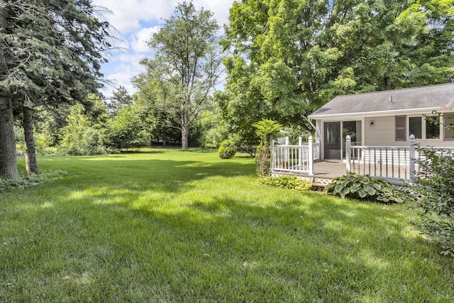 5951 Riverside Dr, Jackson, MI 49201 - view of grassy yard featuring a deck