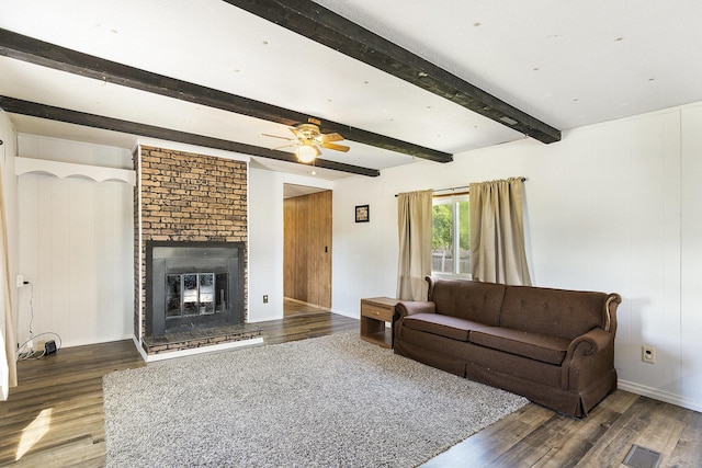 10295 S Osborn Ave, Fremont, MI 49412 - living area featuring wood finished floors, a ceiling fan, a brick fireplace, and beam ceiling