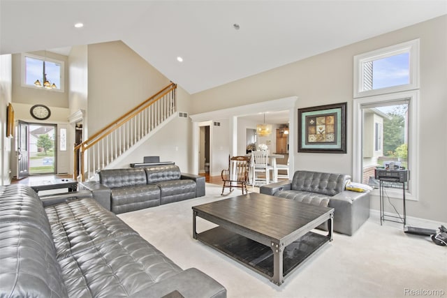 7759 W Branch Ct, Ypsilanti, MI 48197 - carpeted living room with high vaulted ceiling, stairs, and recessed lighting