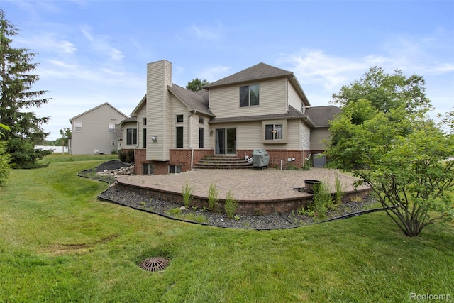 7759 W Branch Ct, Ypsilanti, MI 48197 - back of property featuring a patio area, a chimney, brick siding, and a lawn