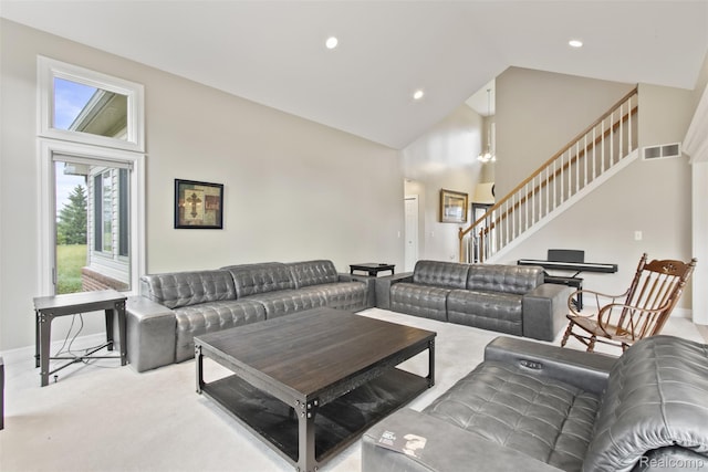 7759 W Branch Ct, Ypsilanti, MI 48197 - carpeted living room with high vaulted ceiling, stairway, and recessed lighting