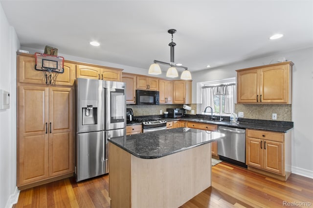7759 W Branch Ct, Ypsilanti, MI 48197 - kitchen with stainless steel appliances, hardwood / wood-style flooring, tasteful backsplash, a kitchen island, and recessed lighting