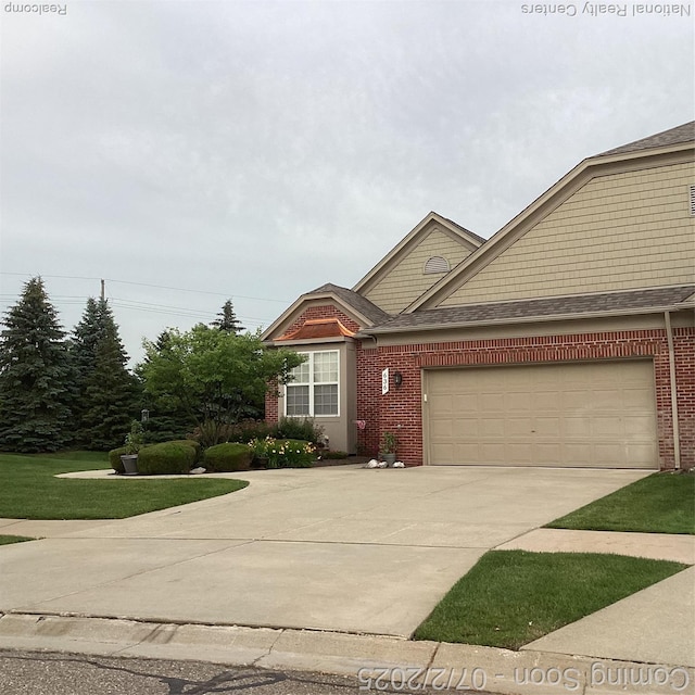 636 Zion Ct S, Howell, MI 48843 - view of front of home with driveway, brick siding, a garage, and a shingled roof