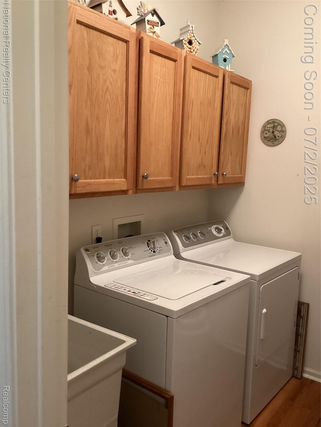636 Zion Ct S, Howell, MI 48843 - laundry room with separate washer and dryer, cabinet space, and wood finished floors