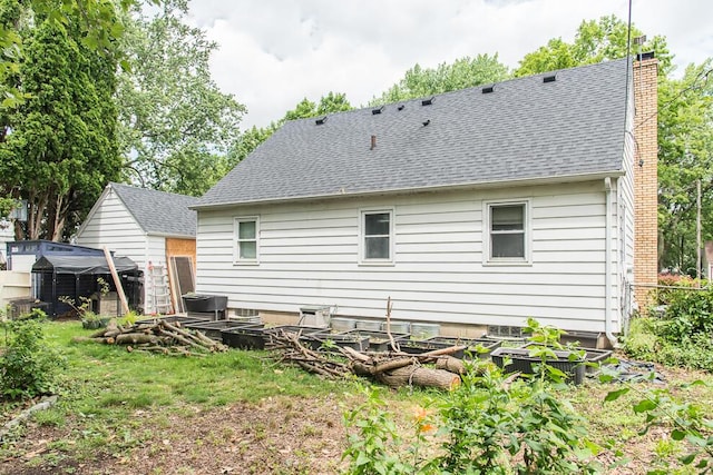1624 Fulton St, Kalamazoo, MI 49001 - back of house featuring roof with shingles and a chimney
