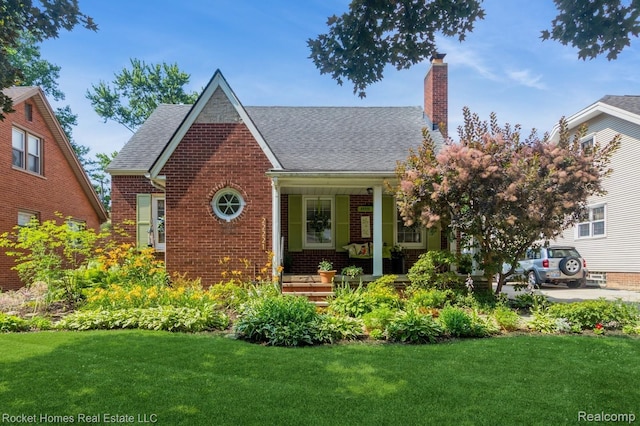 22221 Gregory St, Dearborn, MI 48124 - view of front of property with brick siding, a porch, a front yard, and a chimney