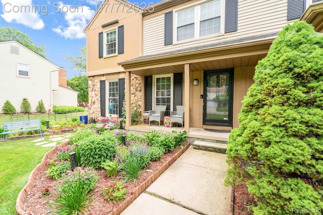 6611 Windmill Ln, West Bloomfield, MI 48324 - view of front of house featuring a porch, stone siding, and stucco siding
