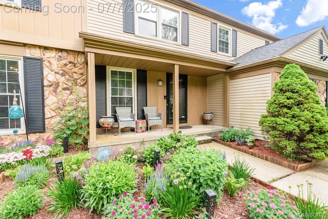 6611 Windmill Ln, West Bloomfield, MI 48324 - property entrance featuring a porch and stone siding
